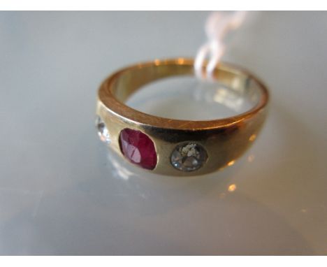 Unmarked yellow metal single stone ruby and two stone diamond set ring