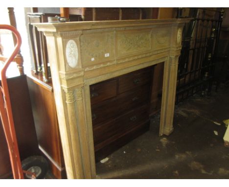 19th Century pine Adam style fire surround decorated with bows and swags and oval classical applied figures, the opening flan