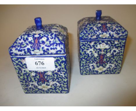 Pair of 20th Century Chinese square shaped canisters with covers decorated with floral designs on a blue ground, red seal mar