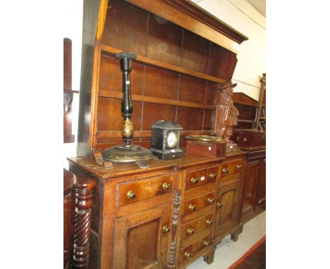 Early 19th Century oak and fruitwood Anglesey dresser, the boarded shelf back above a breakfront base with six drawers and tw