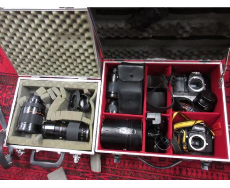 Minolta 35mm SLR camera body with five various lenses and other accessories in two metal cases
