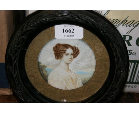 Circular miniature watercolour, head and shoulder portrait of a young lady in a landscape, signed Villiers in a circular ebon