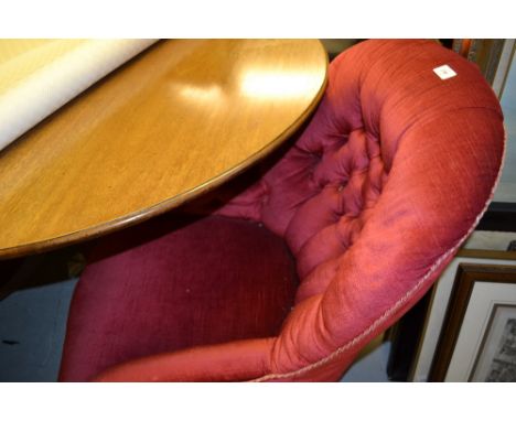 19th Century red velvet upholstered drawing room armchair on turned tapering walnut front supports with ceramic and brass cas