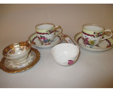 Two Meissen cups and saucers decorated with flowers in puce together with a Meissen cup painted with flowers and a Continenta