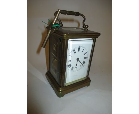 Brass cased carriage clock with enamel dial and Roman numerals, the two train movement striking on a gong