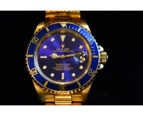 18ct Gold Rolex Submariner Oyster perpetual date wristwatch with blue dial and blue rotating bezel, luminous markers, sweep s