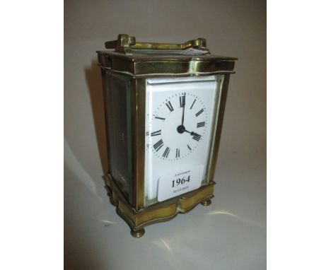 French gilt brass cased serpentine shaped carriage clock having enamel dial with Roman numerals and single train movement, 5i