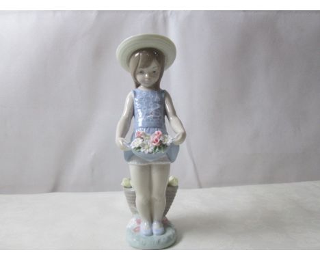 A Lladro girl with flowers carried in skirt (No 1284)