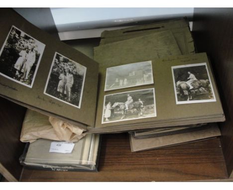 A quantity of vintage photograph albums and postcards