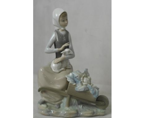 A Lladro girl with lamb and wheelbarrow