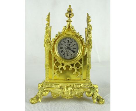 A late 19th  century gilt metal Gothic revival mantel clock:
The case of architectural form, with pocket watch movement inscr
