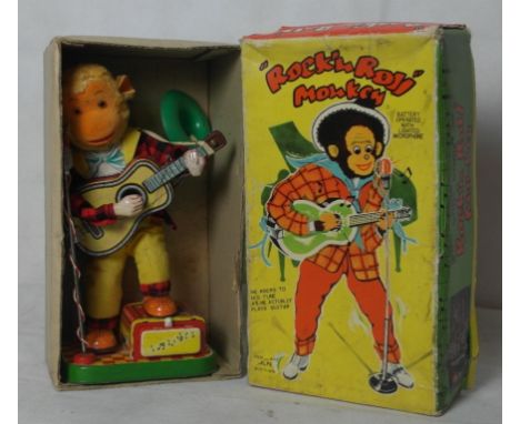 A boxed tinplate automaton in the form of a rock 'n' roll monkey, c1960