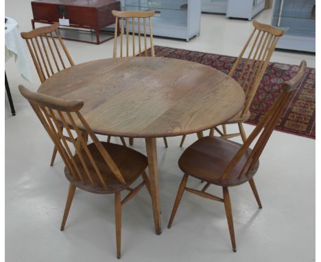 An Ercol pebble table; together with five matching chairs