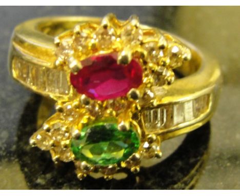 A ruby, diamond and emerald dress ring set in an 18ct mount