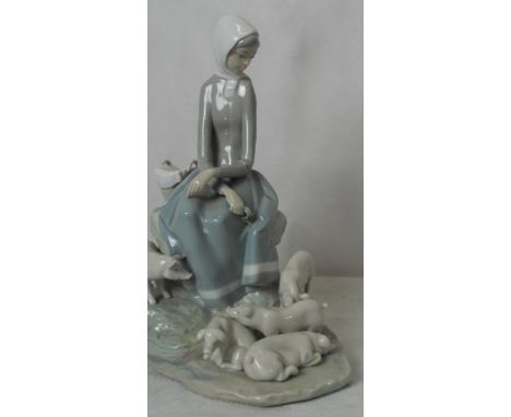 A large figure of a Lladro girl with pigs