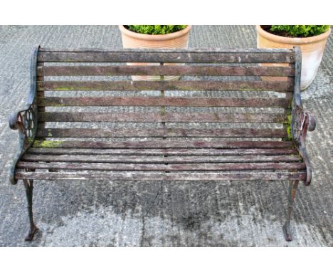 A traditional garden bench with cast iron ends and wooden slates. H72cm