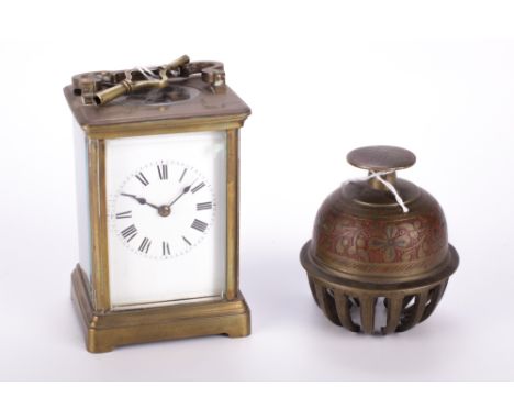 A French carriage clock and a brass bell. Comprising a single gong striking carriage clock with white dial and Roman numerals