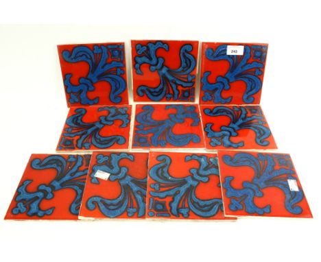 Ten ceramic tiles by Carter Tiles of Poole, Dorset. Decorated with Fleur de Lys pattern in blue on a red background