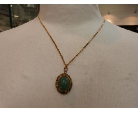A jade style pendant in a yellow metal filligree mount with enamelled decoration on a fine 9ct gold curb chain, approx 24'  a