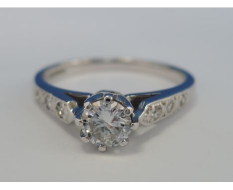 A ladies diamond solitaire ring, approx .45ct having diamond chips to shoulders on an 18ct white gold loop