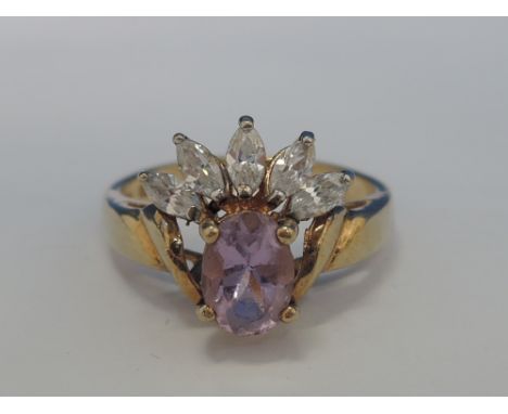 A ladies dress ring having an oval amethyst style stone with cubic zirconia crown decoration in a raised basket mount on a 9c