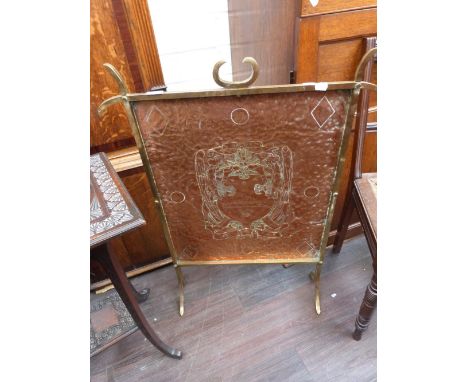 An early 20th century brass and copper firescreen, in the Arts & Crafts style
