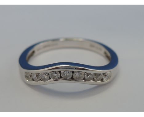 A ladies wish bone eternity ring having 9 channel set diamonds,  approx .25ct in an 18ct white gold loop