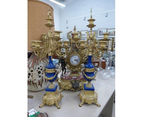 A modern composite clock garniture in the Italian classical style having blue ceramic and rouge marble insets on gilt brass f