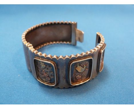 A white metal hinged bangle having scalloped edges and a trio of panels depicting insects in yellow metal,  no marks