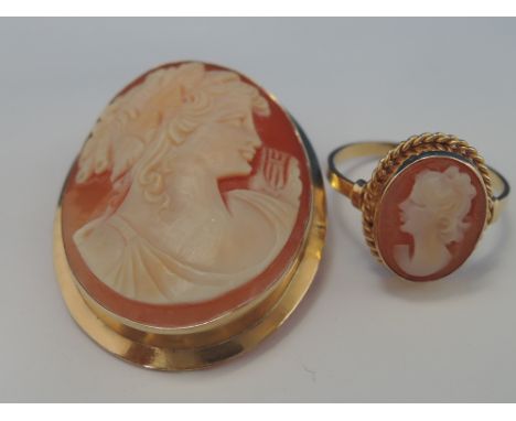 A conche shell cameo brooch depicting a maiden in profile within a plain yellow metal mount stamped 750 and a conche shell ca