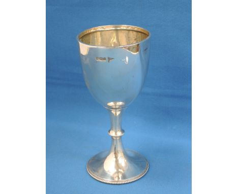 A silver goblet having beaded decoration to base and stem with a wrap over rim, Sheffield 1913, Walker & Hall,  approx 131g