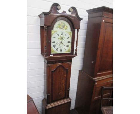 A late 18th/early 19th century oak longcase clock having swan neck and square pillar hood containing painted arch dial and 30