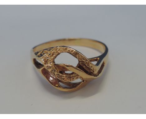 A ladies yellow metal dress ring of stylised form, no marks but tested as 18ct gold,  approx 3.1g