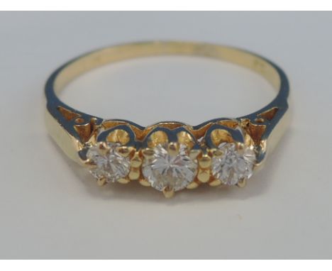 A ladies three stone diamond ring, approx .25ct on an 18ct gold loop, marks worn