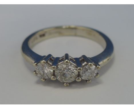 A ladies three stone diamond ring, approx .5ct on a 9ct white gold loop