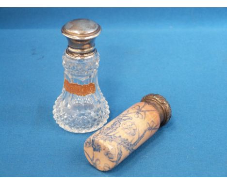A small ceramic scent bottle having blue Hawthorn decoration on peach ground with a silver lid having floral repousse decorat