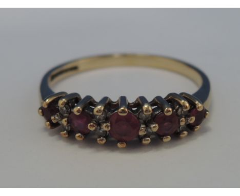 A five stone graduated ruby eternity ring interspersed by diamond chips on a 9ct gold loop