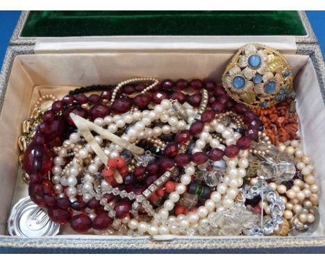 A travel jewellery box retailed by Asprey London containing a selection of vintage costume jewellery including, coral, crysta