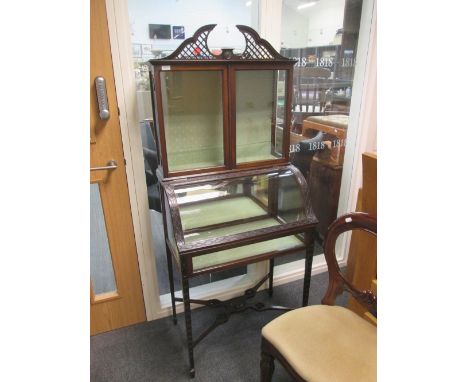 A late 19th century mahogany display cabinet in the Chippendale style having swan neck over standard and lift bow glass secti