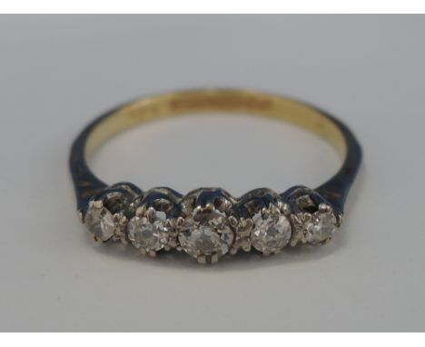 A ladies 5 stone graduated diamond dress ring on a yellow metal loop stamped 18ct plat