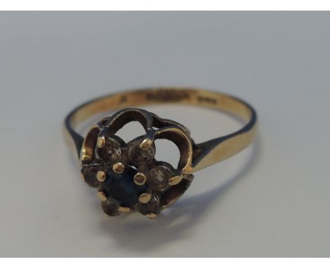 A ladies dress ring having a sapphire and cubic zirconia cluster in a daisy style mount on a 9ct gold loop