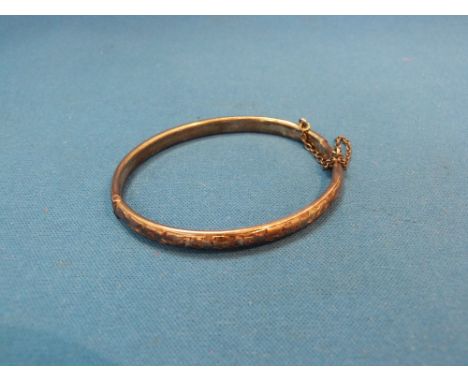 A narrow HM silver hinged bangle having floral decoration