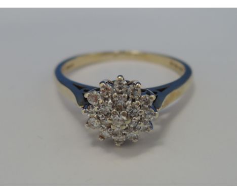 A ladies dress ring having a triple diamond cluster on a 9ct gold loop