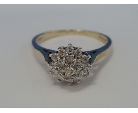 A ladies dress ring having a triple diamond cluster on a 9ct gold loop