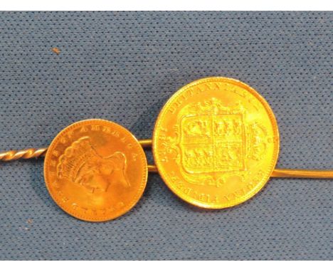 Two yellow metal stick pins, one 1887 Half Sovereign and one American gold One Dollar coin