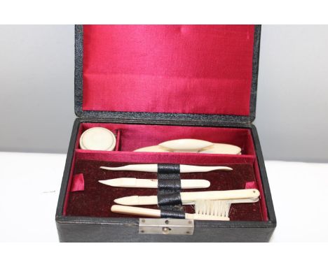 A cased vintage bone manicure set 