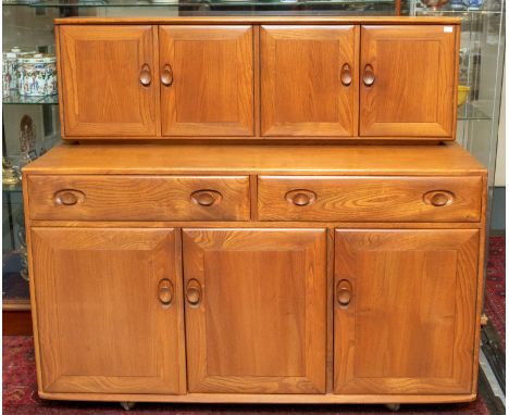 Ercol - a "Windsor" buffet sideboard, the base section with three doors with two drawers above an upper section with two doub