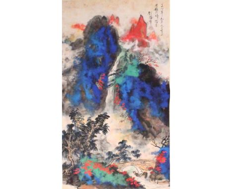 A CHINESE HANGING SCROLL PICTURE ON PAPER, in the style of Zhang Daqian, depicting a mountainous landscape in vivid colouring