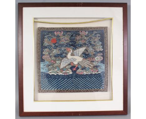 A 19TH/20TH CENTURY FRAMED CHINESE KESI RANK BADGE, of the Fifth Civil Rank, depicting a silver pheasant amidst cloud scrolls