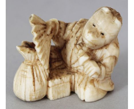 A SMALL JAPANESE MEIJI PERIOD IVORY NETSUKE OF A SEATED PERFORMER, unsigned, holding a fan and wearing a fox mask, 1.1in wide